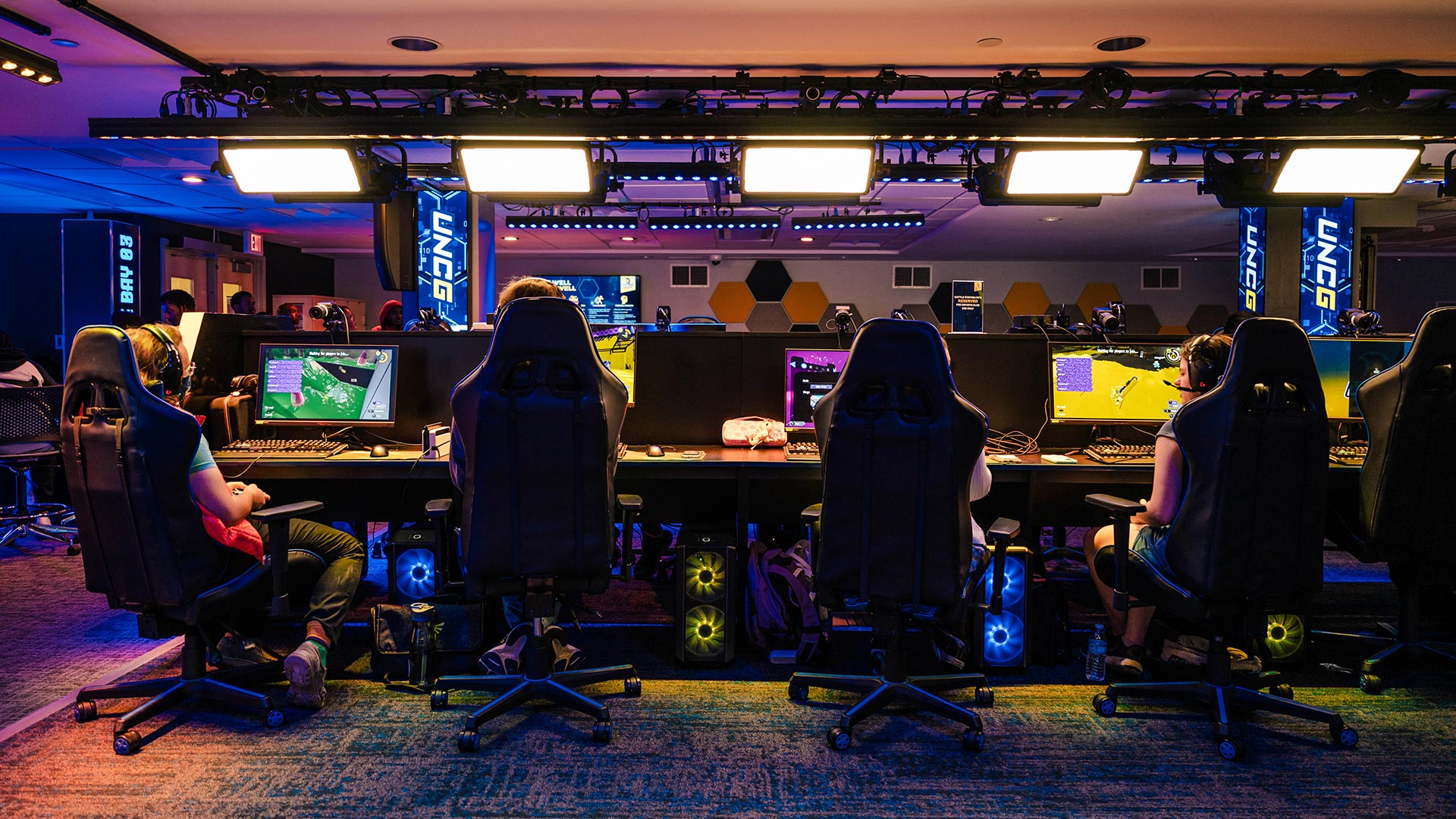 Four students sitting at Esports computer consoles.