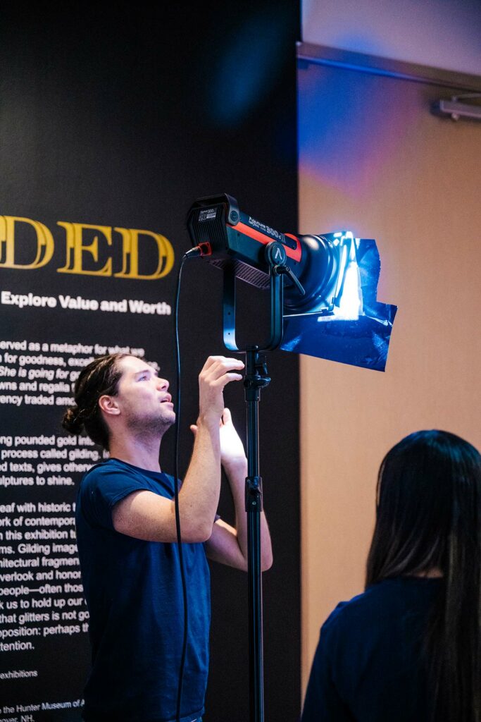Videographer holding studio light on photo shoot