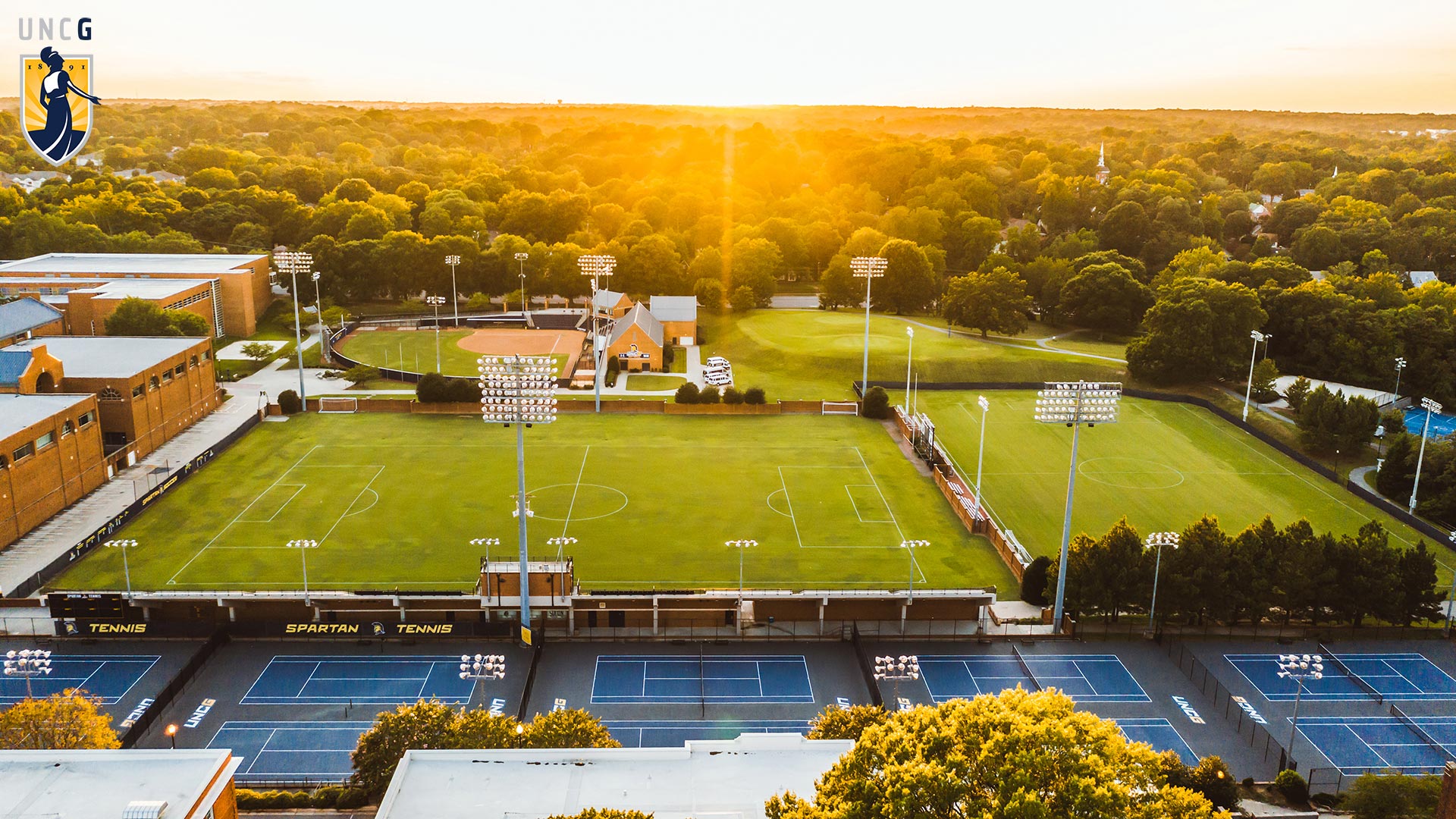 Aerial view of the UNCG Soccer field with the UNCG logo in the top left corner
