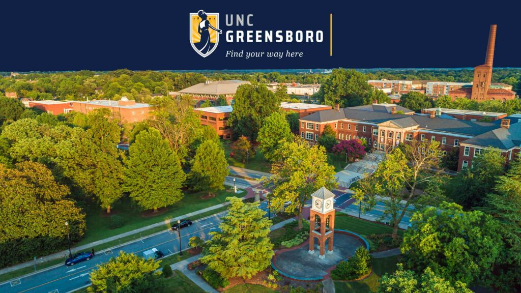 wallpaper image showing campus aerial image of belltower. Blue banner at the top with UNCG logo Find Your Way Here