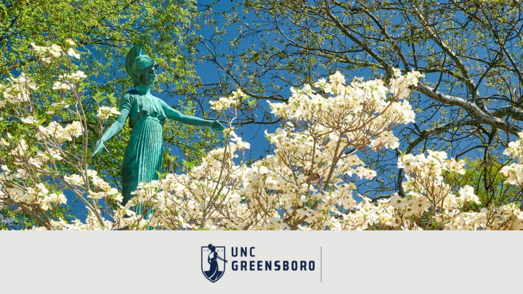 Wallpaper image of Minerva Statue among trees with spring foliage